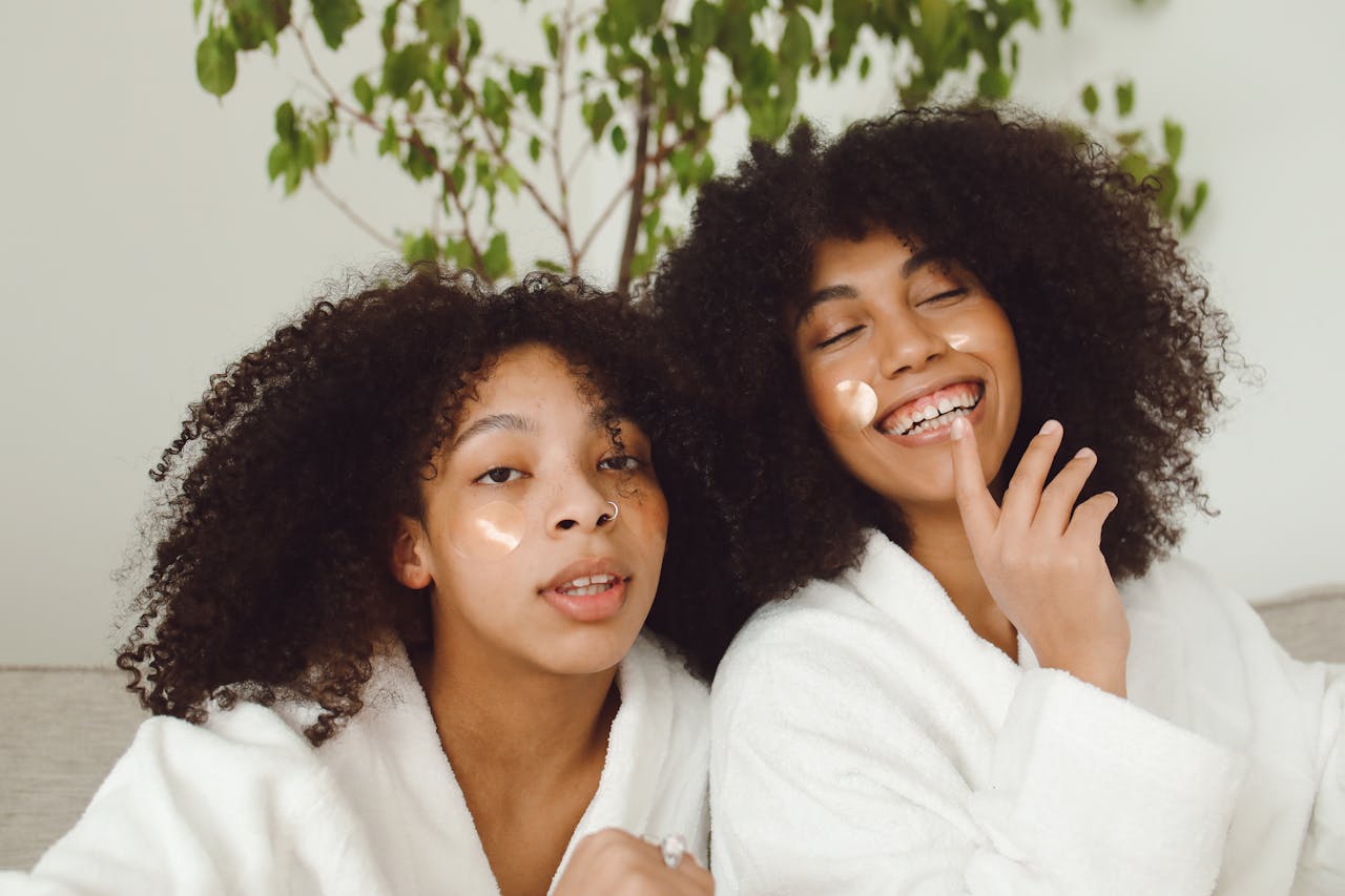Two women enjoying a skincare routine, showcasing happiness and natural beauty.